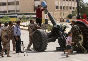 Free Syrian Army fighter a prepare to fire a home-made rocket in Ashrafieh